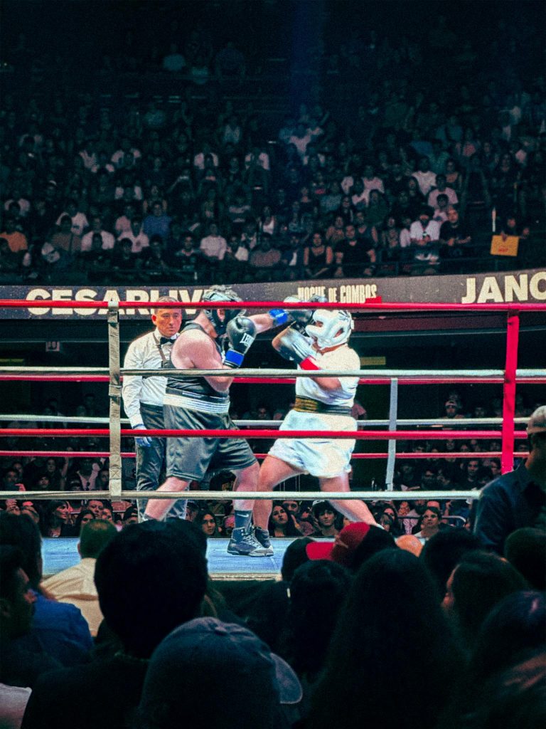 A thrilling boxing match with an energetic crowd in an indoor stadium setting.