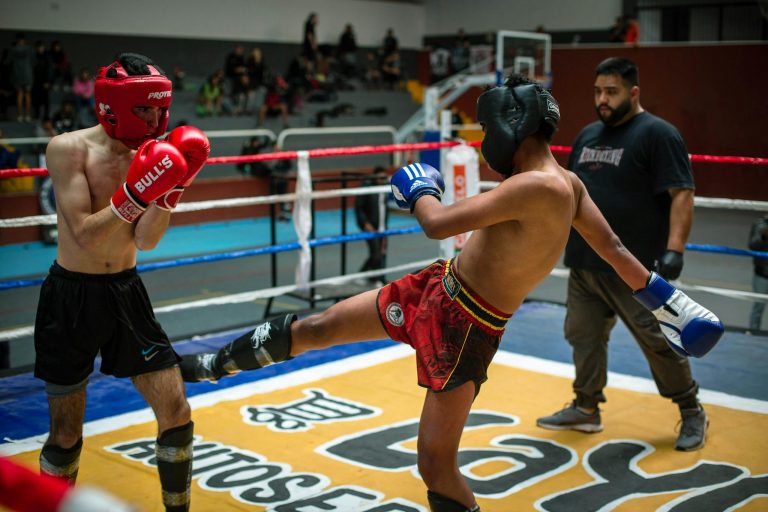 Exciting boxing match featuring a dynamic kick captured in action, showcasing determination and skill.